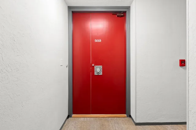 a view of a room with red door