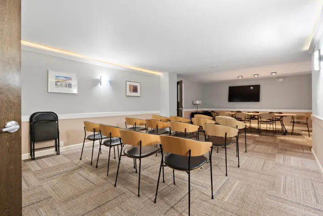 a view of a livingroom with furniture and a flat screen tv