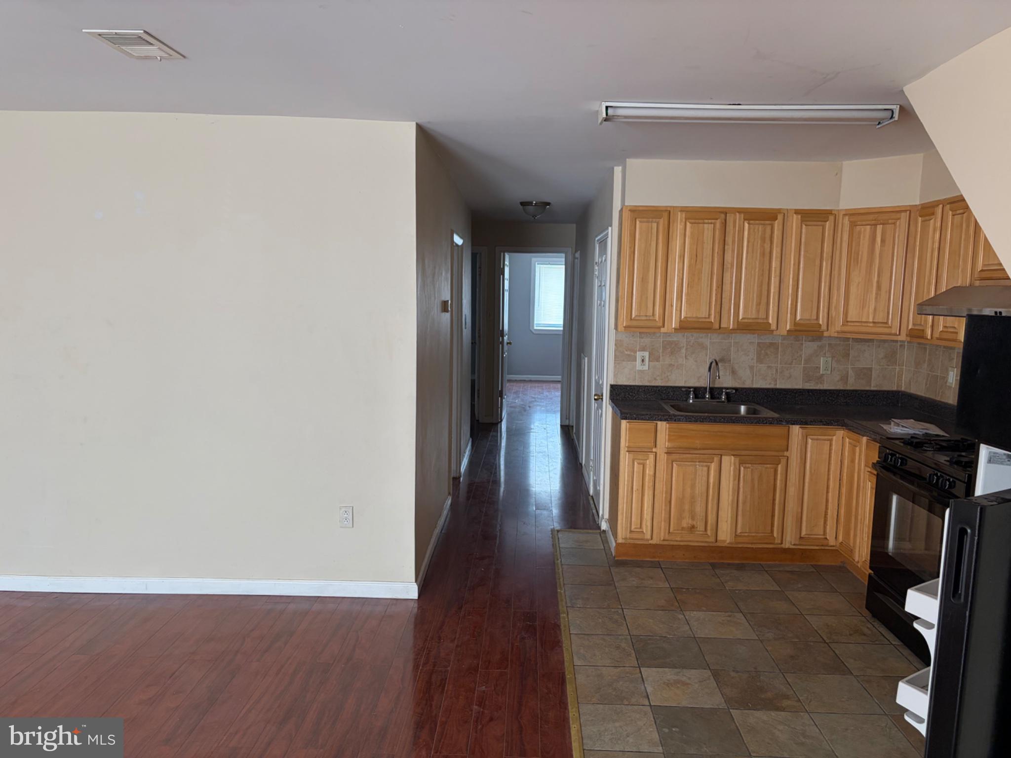 3273 Red Lion Road Philadelphia, PA 19114 - Photo 2 of 9 a view of a kitchen with a refrigerator a window and wooden floor