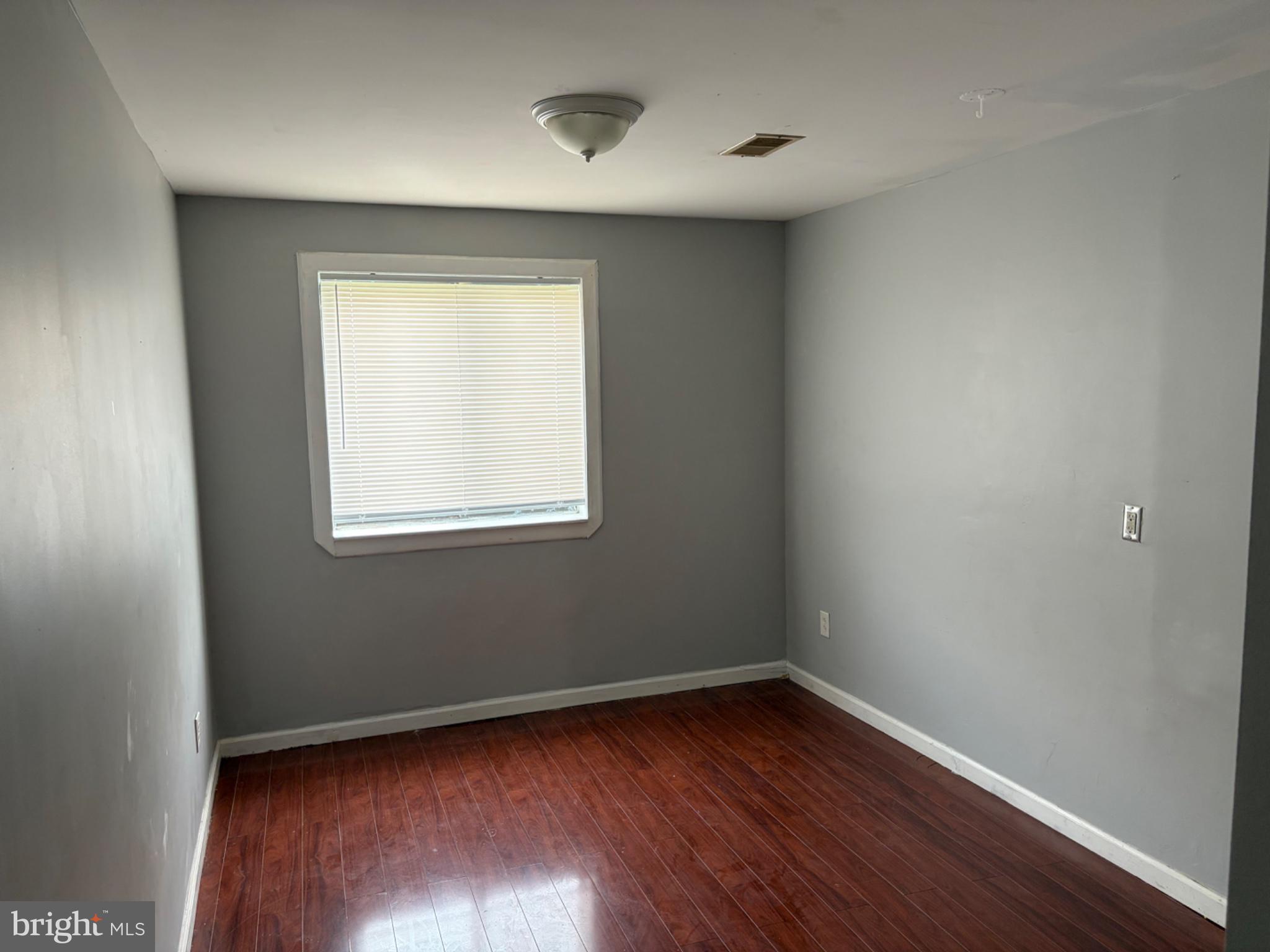 3273 Red Lion Road Philadelphia, PA 19114 - Photo 7 of 9 an empty room with wooden floor and windows