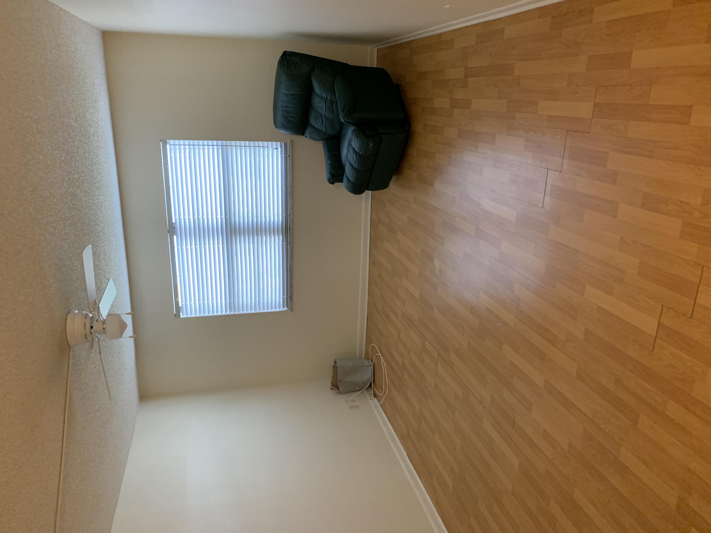 9273 Southwest 8th Street, Unit 416 Boca Raton, FL 33428 - Photo 9 of 14 a living room with furniture and a window