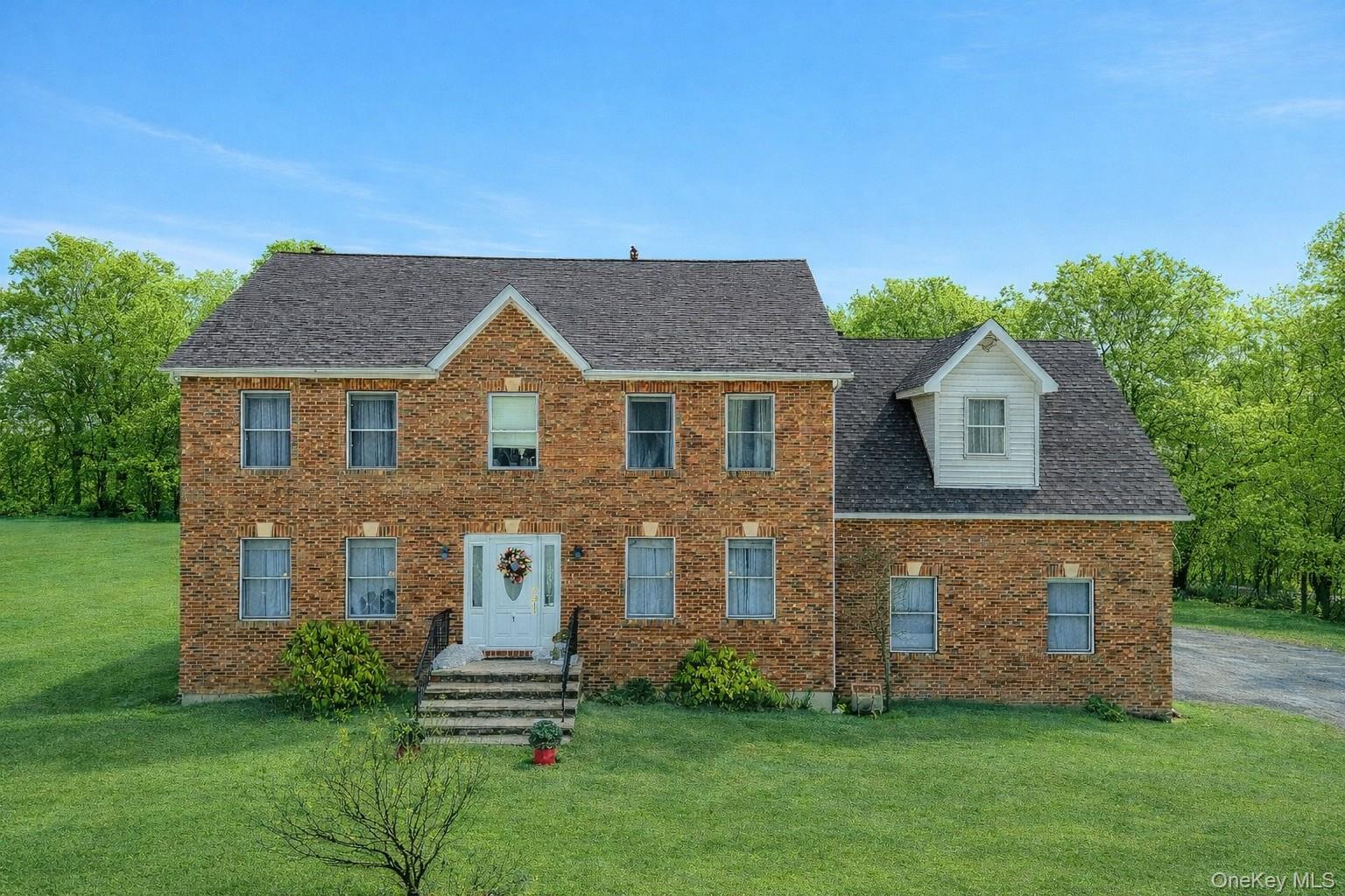 7 Angela's Way Goshen, NY 10924 - Photo 1 of 45 Colonial home featuring a front yard, brick siding, and entry steps