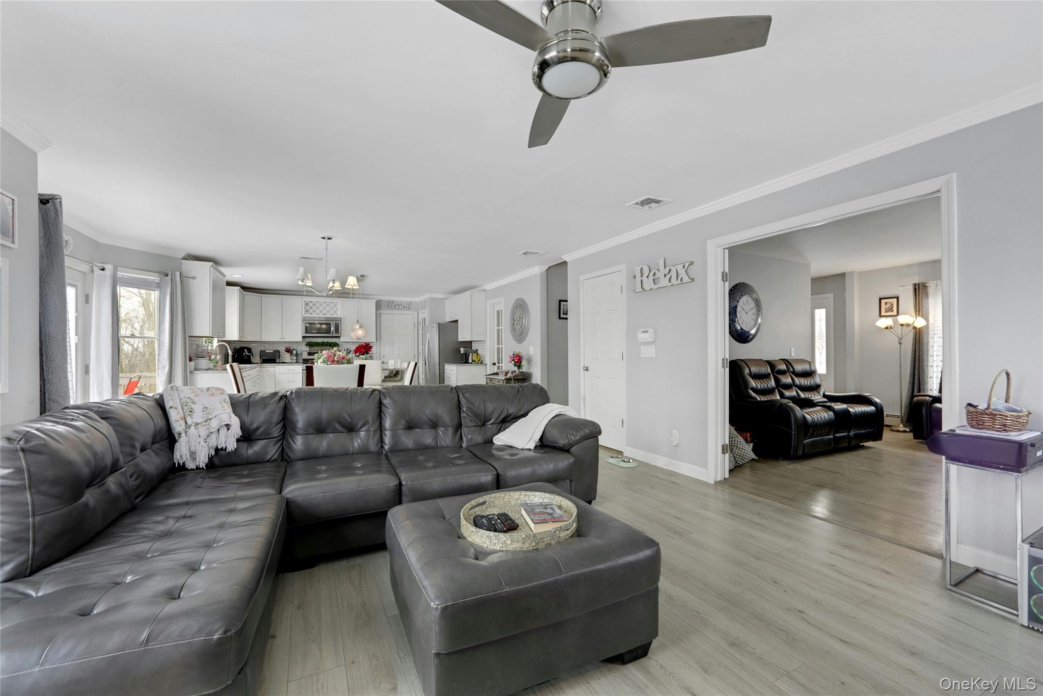 7 Angela's Way Goshen, NY 10924 - Photo 13 of 45 Living area featuring ornamental molding, suspended lighting, light wood-type flooring, and a ceiling fan