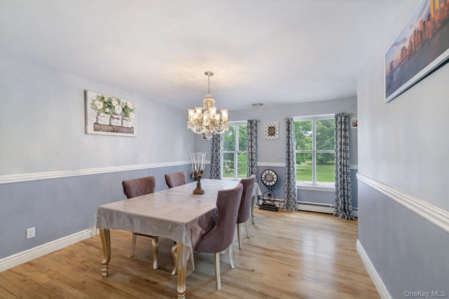 7 Angela's Way Goshen, NY 10924 - Photo 16 of 45 Dining area featuring light wood-type flooring and a chandelier