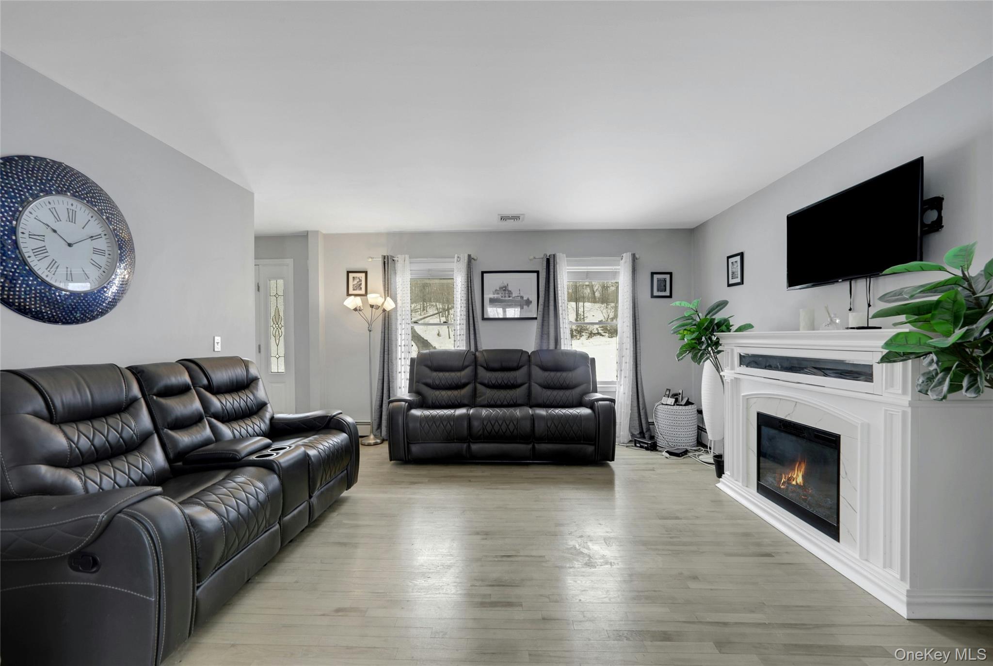 7 Angela's Way Goshen, NY 10924 - Photo 6 of 45 Living room featuring light wood-style flooring and a glass covered fireplace