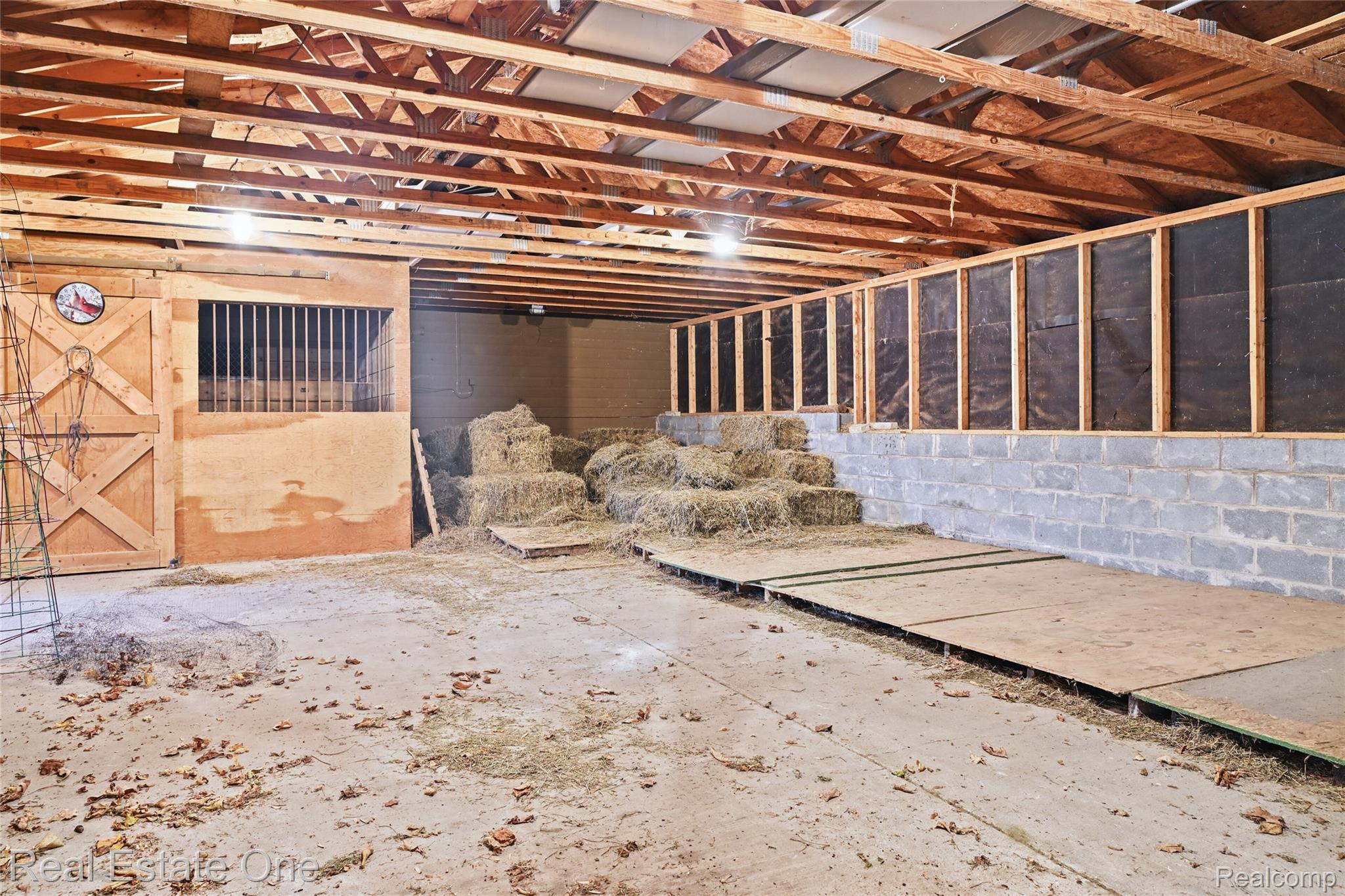 895 Rowe Road Milford, MI 48380 - Photo 25 of 50 Barn 1 Exposed wood beam ceiling, concrete block foundation, wood-framed walls, and a stable door