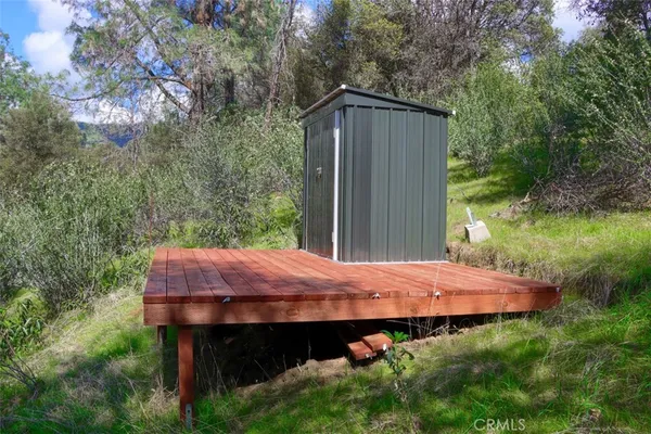 a view of backyard with barn table and chairs