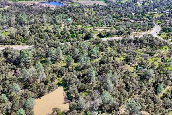 an aerial view of a houses with a yard