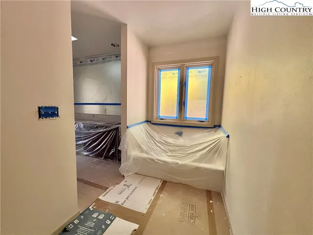 a view of empty room with wooden floor and fireplace