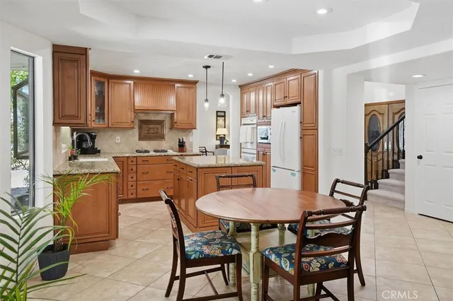 a view of a dining room with furniture and a kitchen