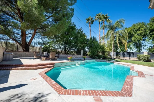 a view of a swimming pool with a patio
