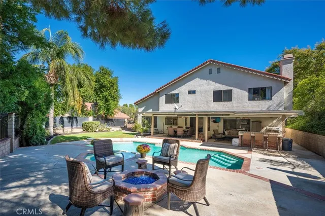a view of backyard of house with seating space