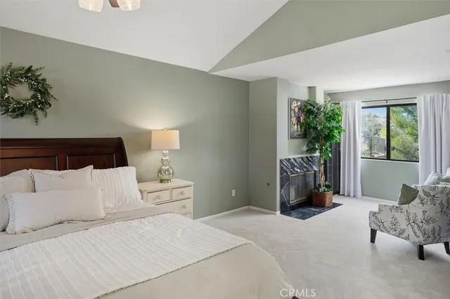 a bedroom with a large bed and a window