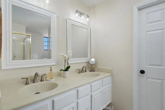 a bathroom with 2 sink and a mirror