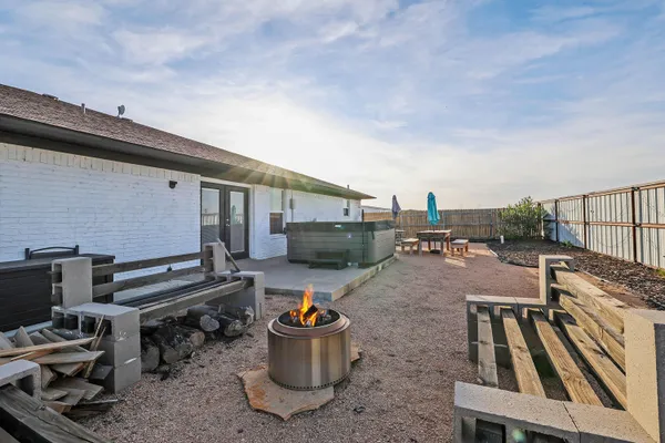 a view of a backyard with sitting area