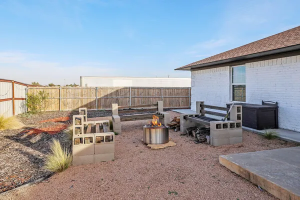 a view of a terrace with furniture and a backyard