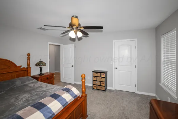 a bedroom with bed and window