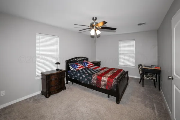 a bedroom with a bed dresser and a window