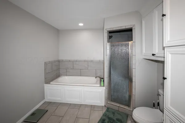 a bathroom with a toilet and a shower