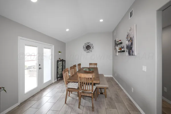 a dining room with furniture and window