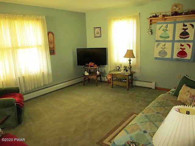 996 Cortez Road Lake Ariel, PA 18436 - Photo 29 of 55 a living room with furniture and a flat screen tv