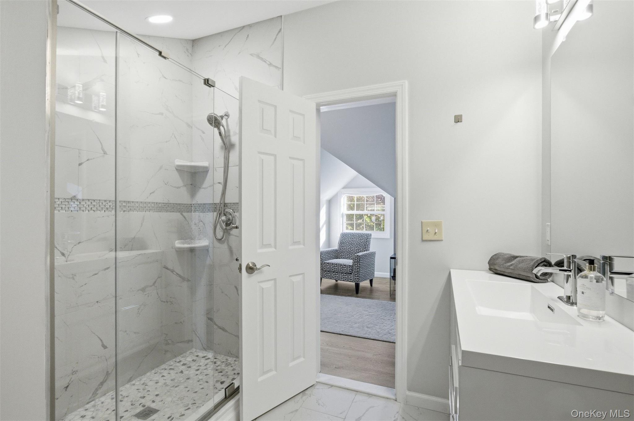 33 A Newtown Road Hampton Bays, NY 11946 - Photo 43 of 50 Full bath with light marble finish floors, vanity, and a marble finish shower