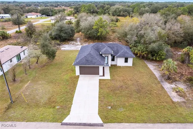 a aerial view of a house with a yard and lake view