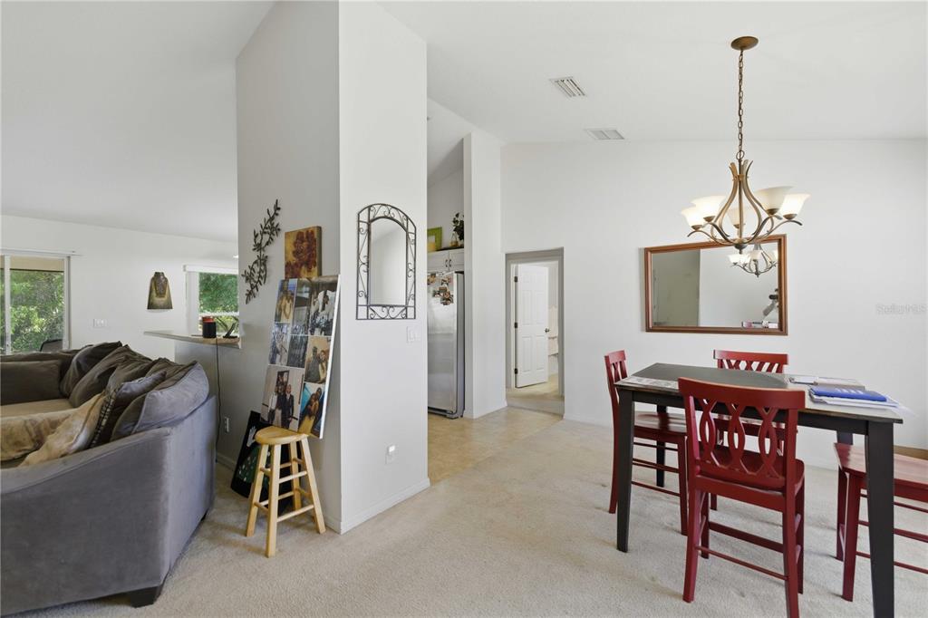 3959 Southwest 129th Street Ocala, FL 34473 - Photo 8 of 27 a living room with furniture and a chandelier