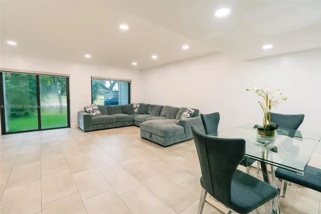 a living room with furniture and a floor to ceiling window