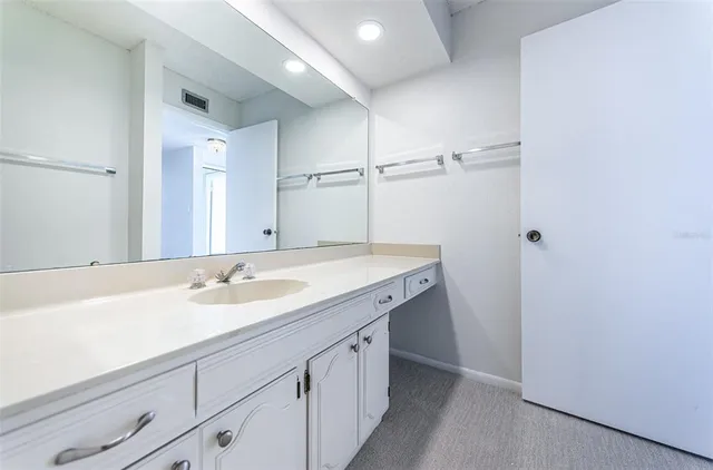 a dining room with furniture a chandelier and wooden floor