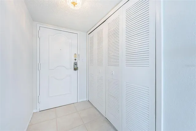 a living room with couches and a dining table with kitchen view