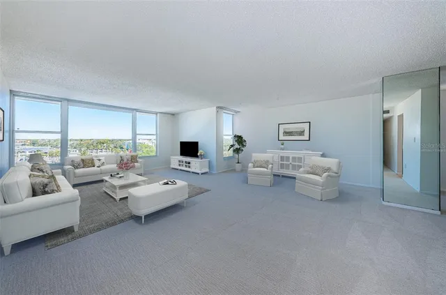 a living room with furniture a rug and a flat screen tv