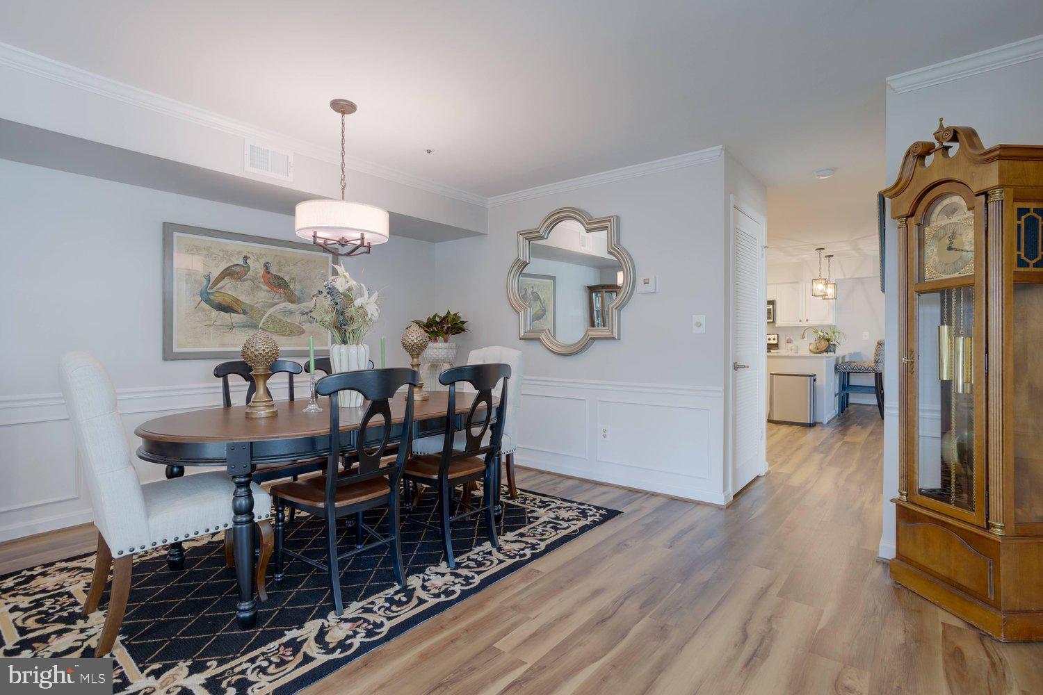 403 Fortress Way, Unit 403 Occoquan, VA 22125 - Photo 11 of 66 a view of a dining room with furniture wooden floor and chandelier