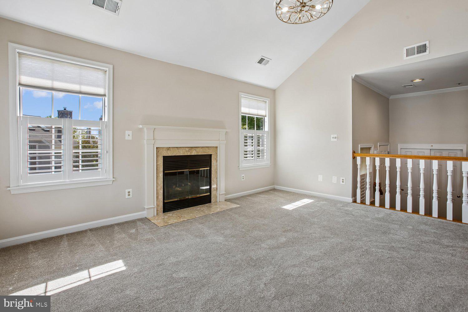 403 Fortress Way, Unit 403 Occoquan, VA 22125 - Photo 20 of 66 a view of an empty room with a fireplace and a window