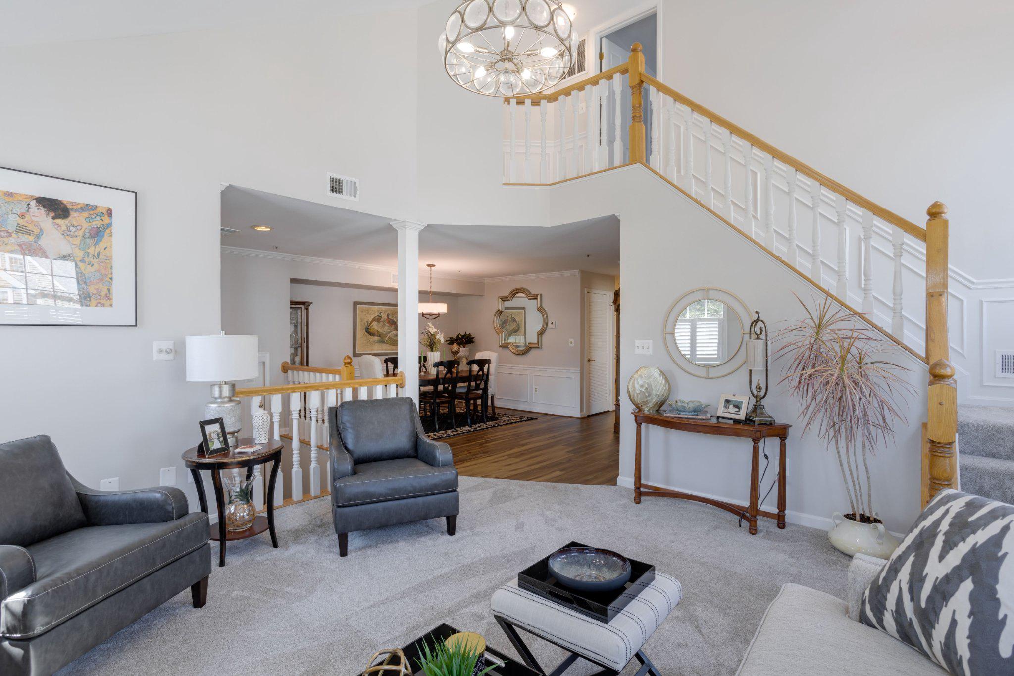 403 Fortress Way, Unit 403 Occoquan, VA 22125 - Photo 3 of 66 a living room with furniture a rug and a chandelier
