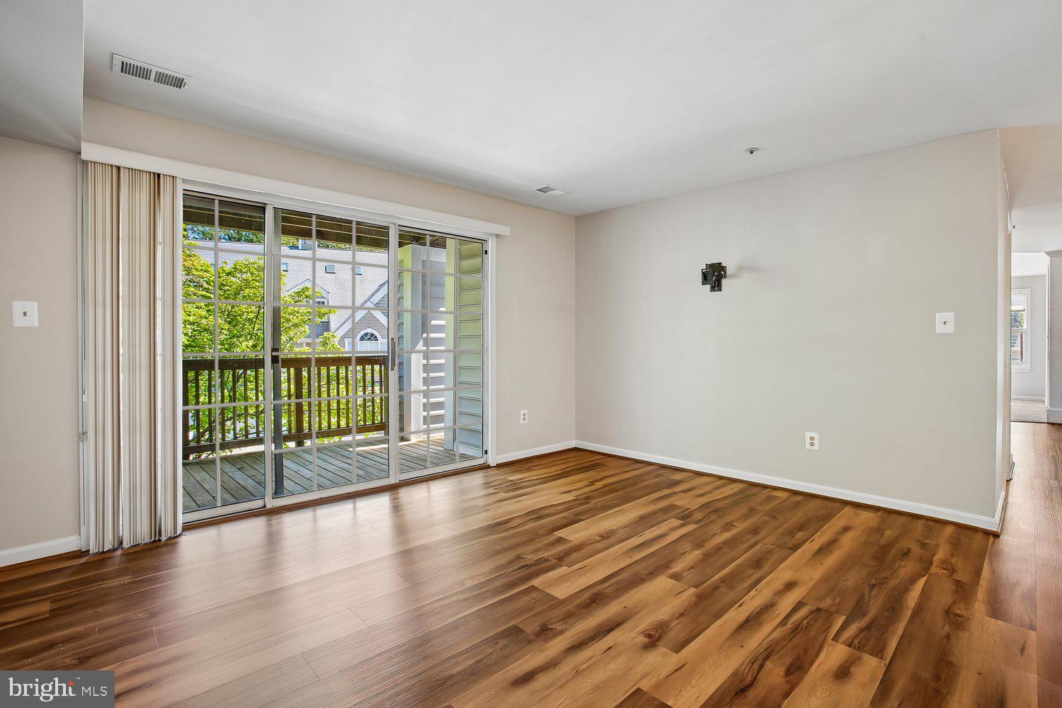 403 Fortress Way, Unit 403 Occoquan, VA 22125 - Photo 34 of 66 a view of an empty room with wooden floor and a window