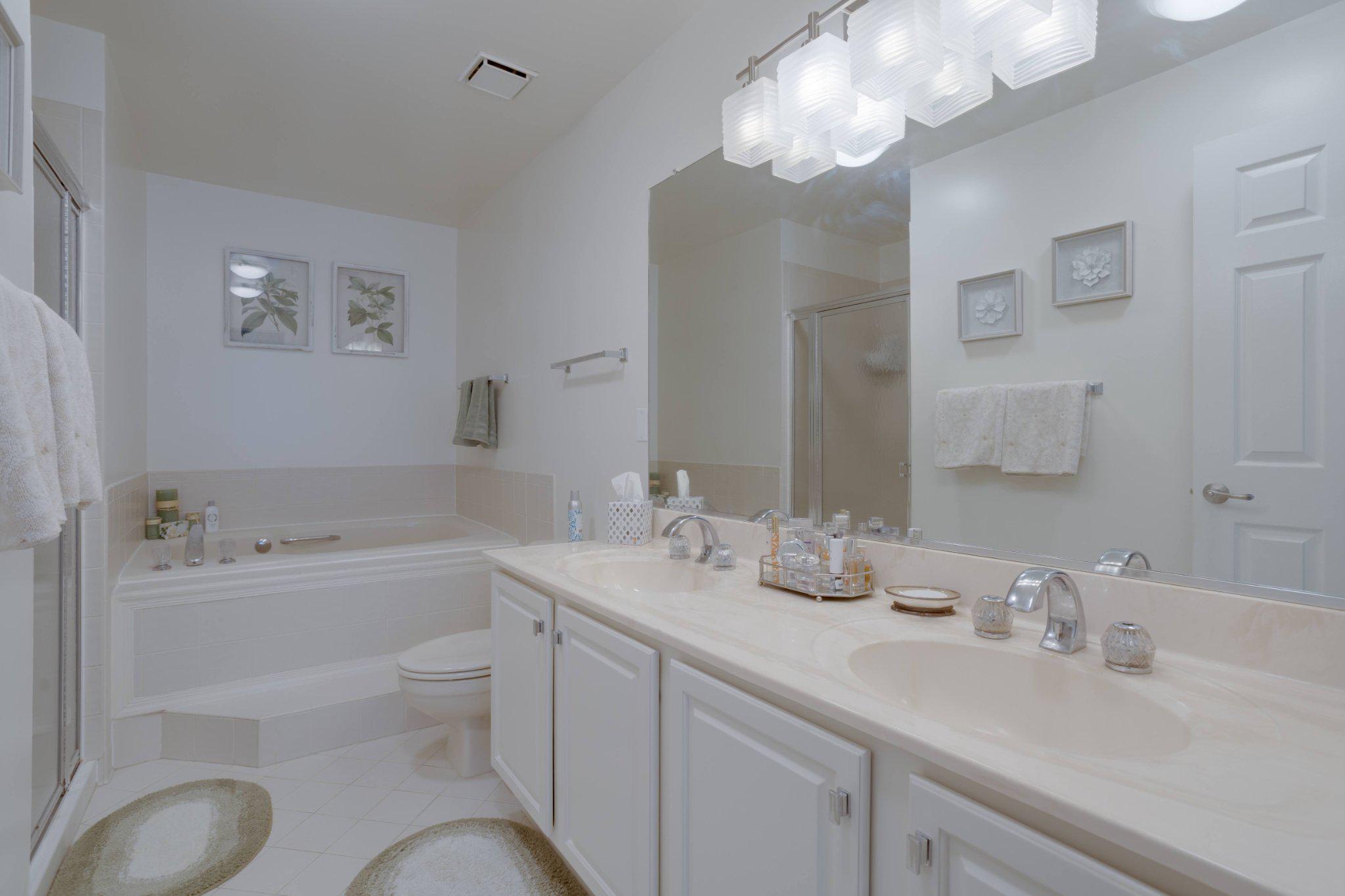 403 Fortress Way, Unit 403 Occoquan, VA 22125 - Photo 40 of 66 a bathroom with a granite countertop sink toilet a large mirror and shower