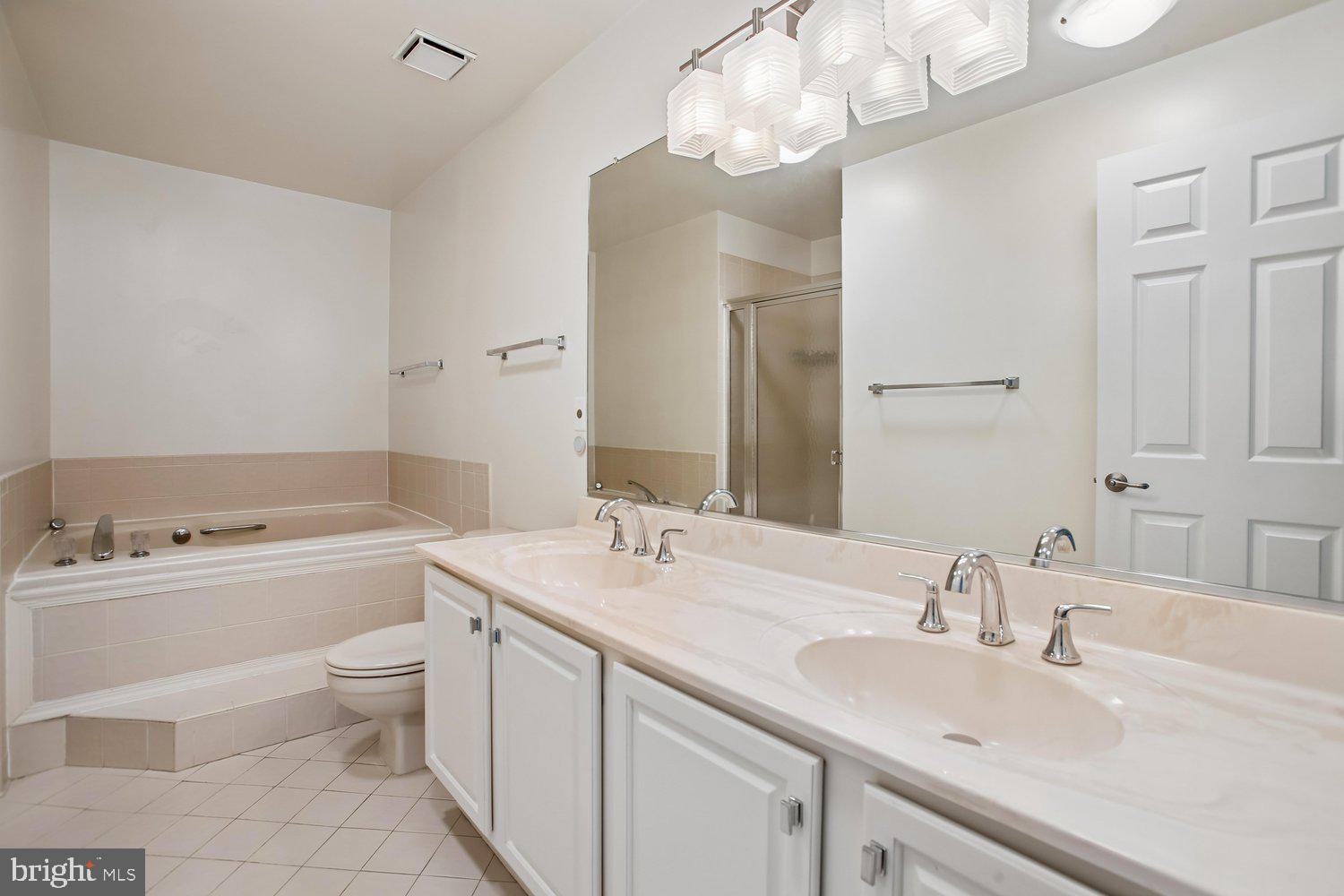 403 Fortress Way, Unit 403 Occoquan, VA 22125 - Photo 42 of 66 a bathroom with a sink a toilet and a large mirror