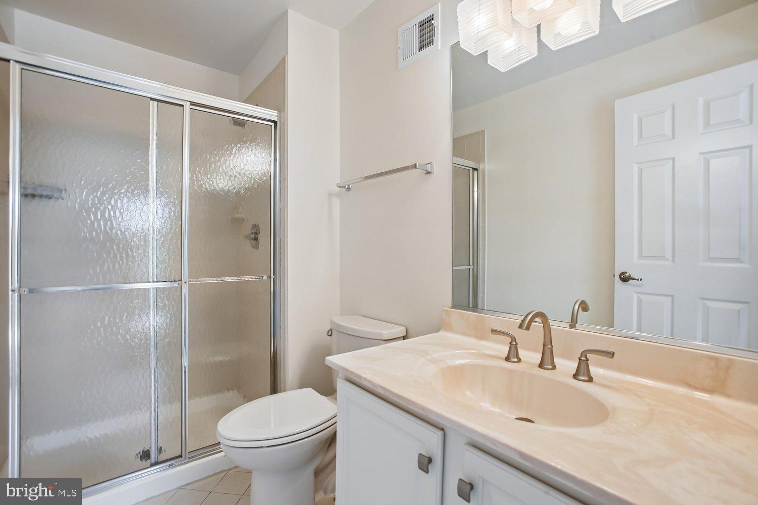 403 Fortress Way, Unit 403 Occoquan, VA 22125 - Photo 47 of 66 a bathroom with a sink toilet and shower