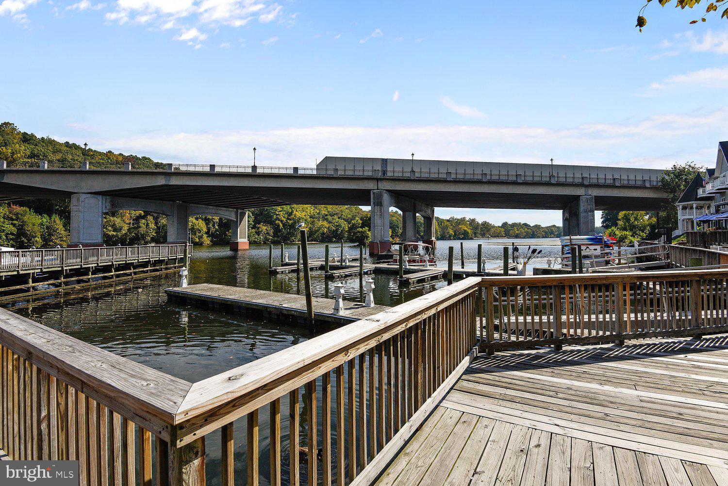 403 Fortress Way, Unit 403 Occoquan, VA 22125 - Photo 55 of 66 Scenic waterfront with a bridge backdrop.