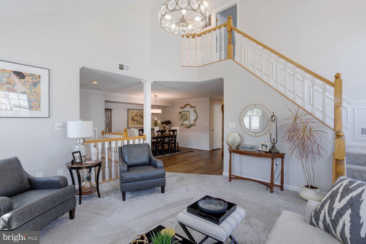 403 Fortress Way, Unit 403 Occoquan, VA 22125 - Photo 10 of 66 a living room with furniture a table and a chandelier