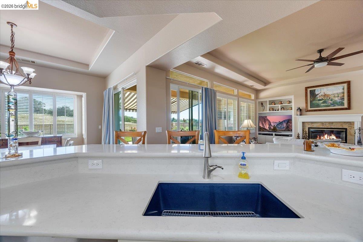 158 Rock Ridge Lane Copperopolis, CA 95228 - Photo 21 of 72 Kitchen island with solid surface countertop and undermount sink featuring a modern faucet