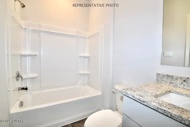 a bathroom with a granite countertop sink toilet and bathtub