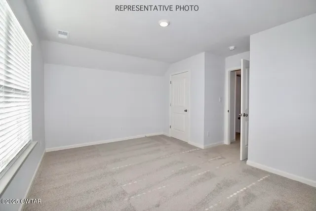 an empty room with windows and closet