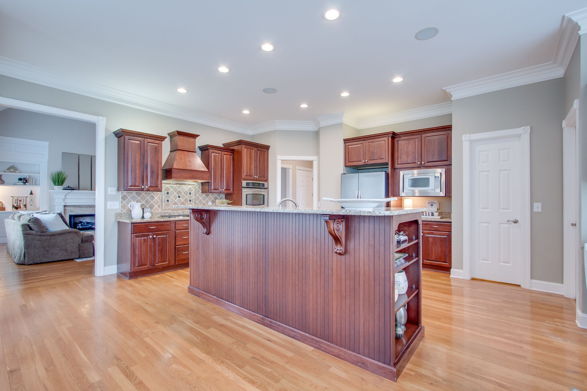 416 Sandcastle Road Franklin, TN 37069 - Photo 18 of 57 a kitchen with stainless steel appliances kitchen island granite countertop wooden cabinets and a sink