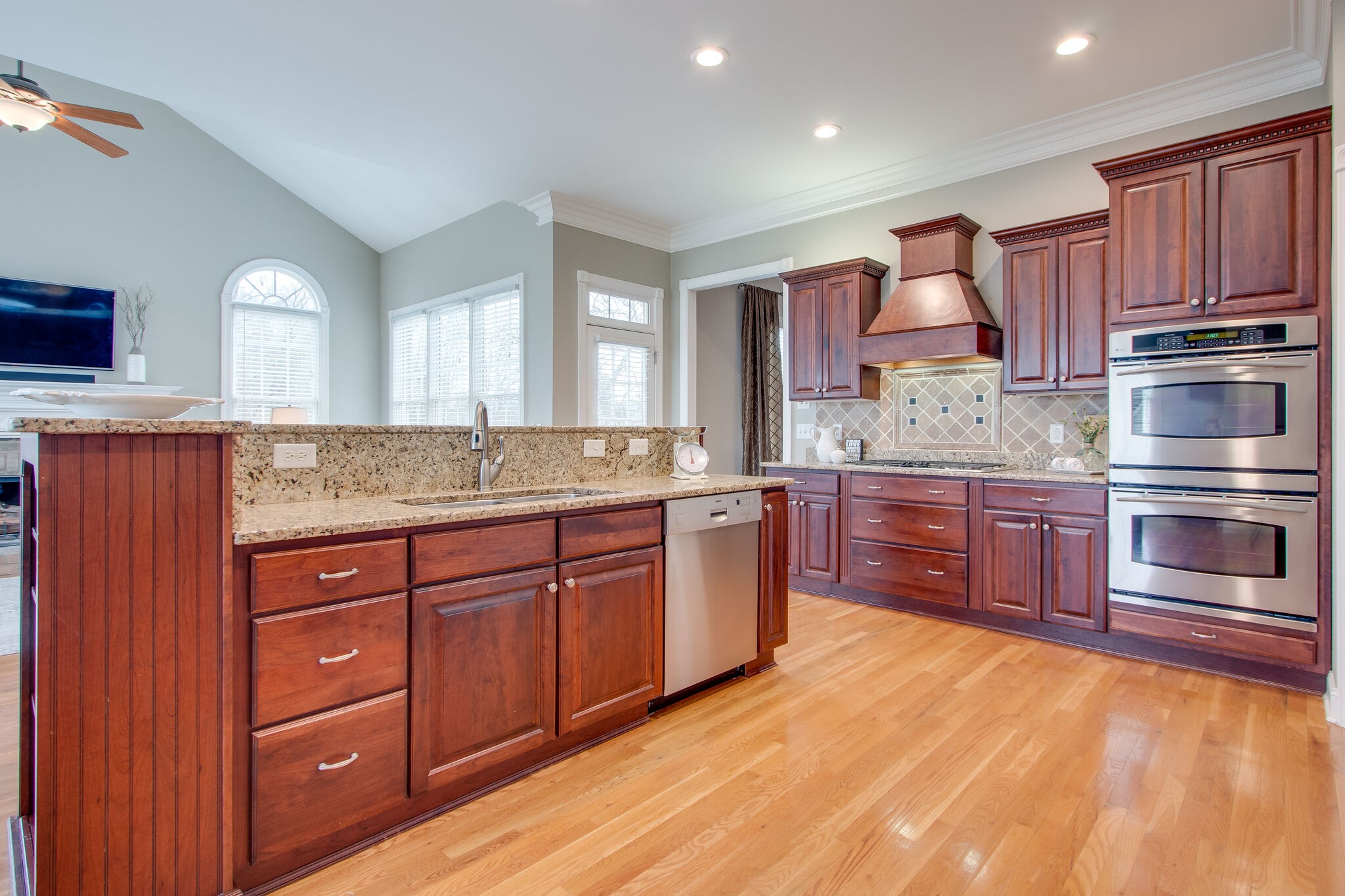 416 Sandcastle Road Franklin, TN 37069 - Photo 20 of 57 a kitchen with stainless steel appliances granite countertop a stove a sink dishwasher a microwave oven and a refrigerator with wooden cabinets