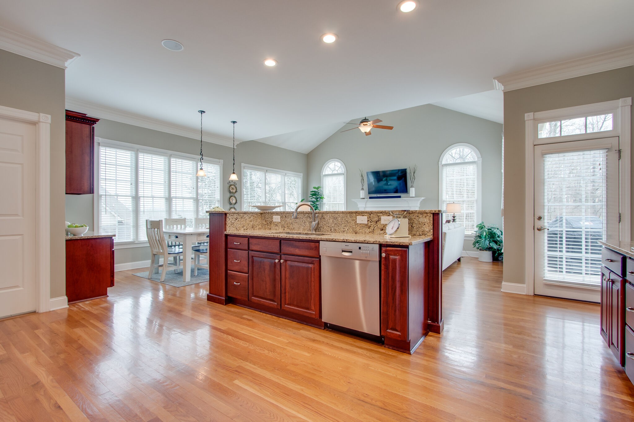 416 Sandcastle Road Franklin, TN 37069 - Photo 21 of 57 a large kitchen with stainless steel appliances granite countertop a refrigerator a stove a dining table and chairs with wooden floor