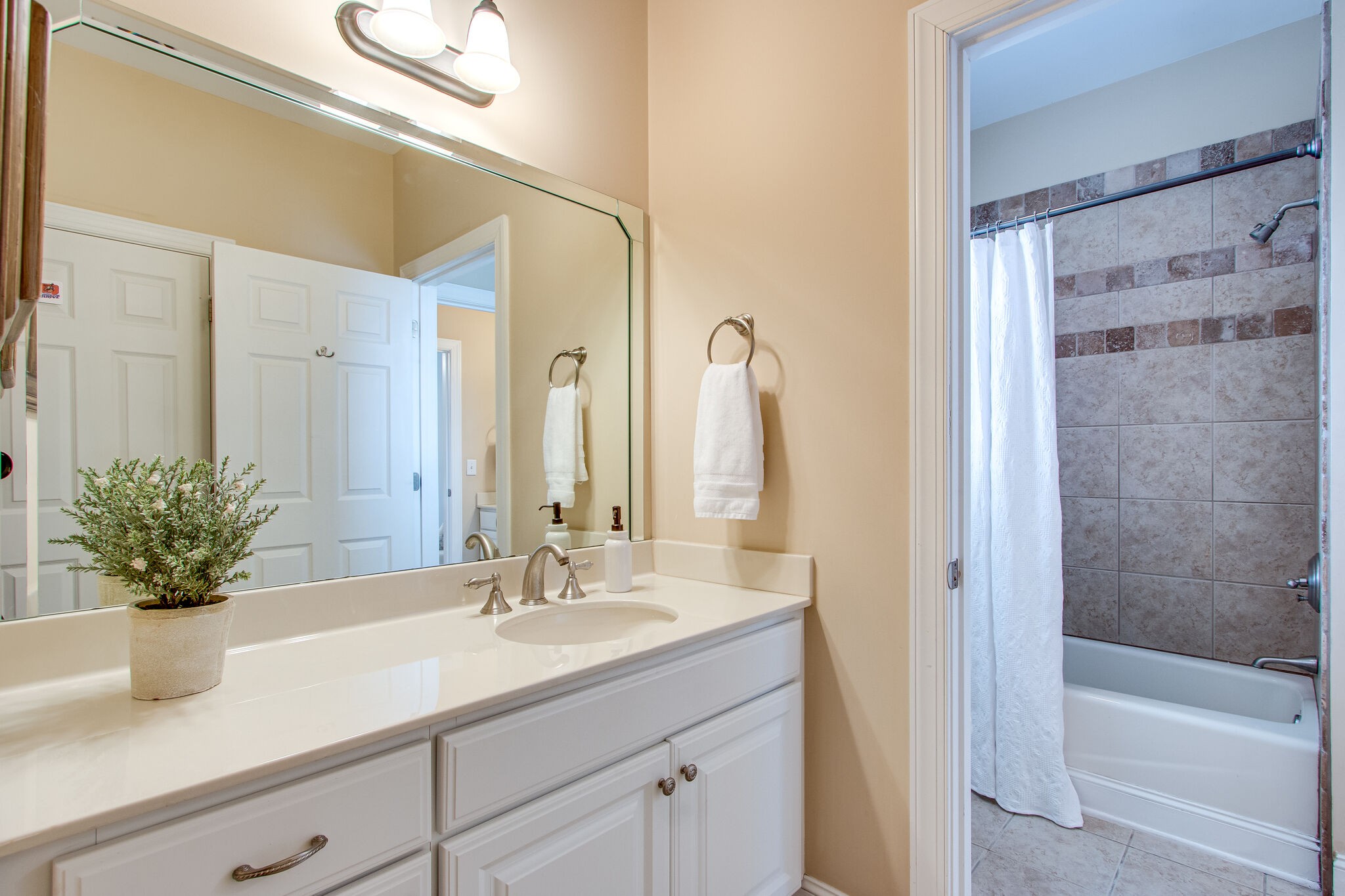 416 Sandcastle Road Franklin, TN 37069 - Photo 44 of 57 a bathroom with a granite countertop sink a mirror a bathtub and shower