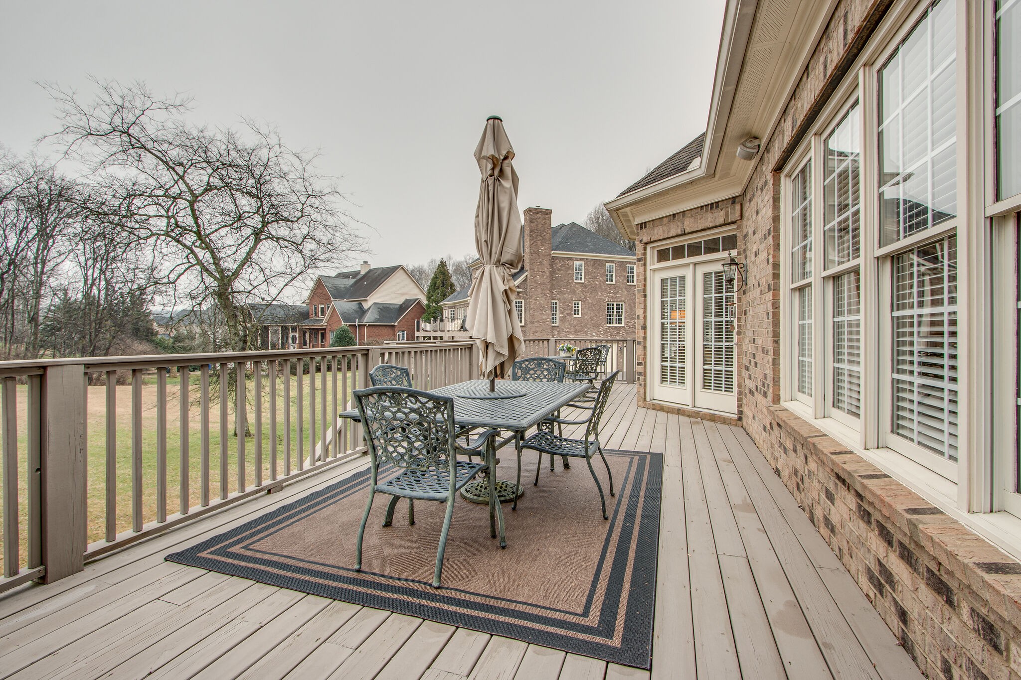 416 Sandcastle Road Franklin, TN 37069 - Photo 46 of 57 a view of a roof deck with table and chairs and wooden floor