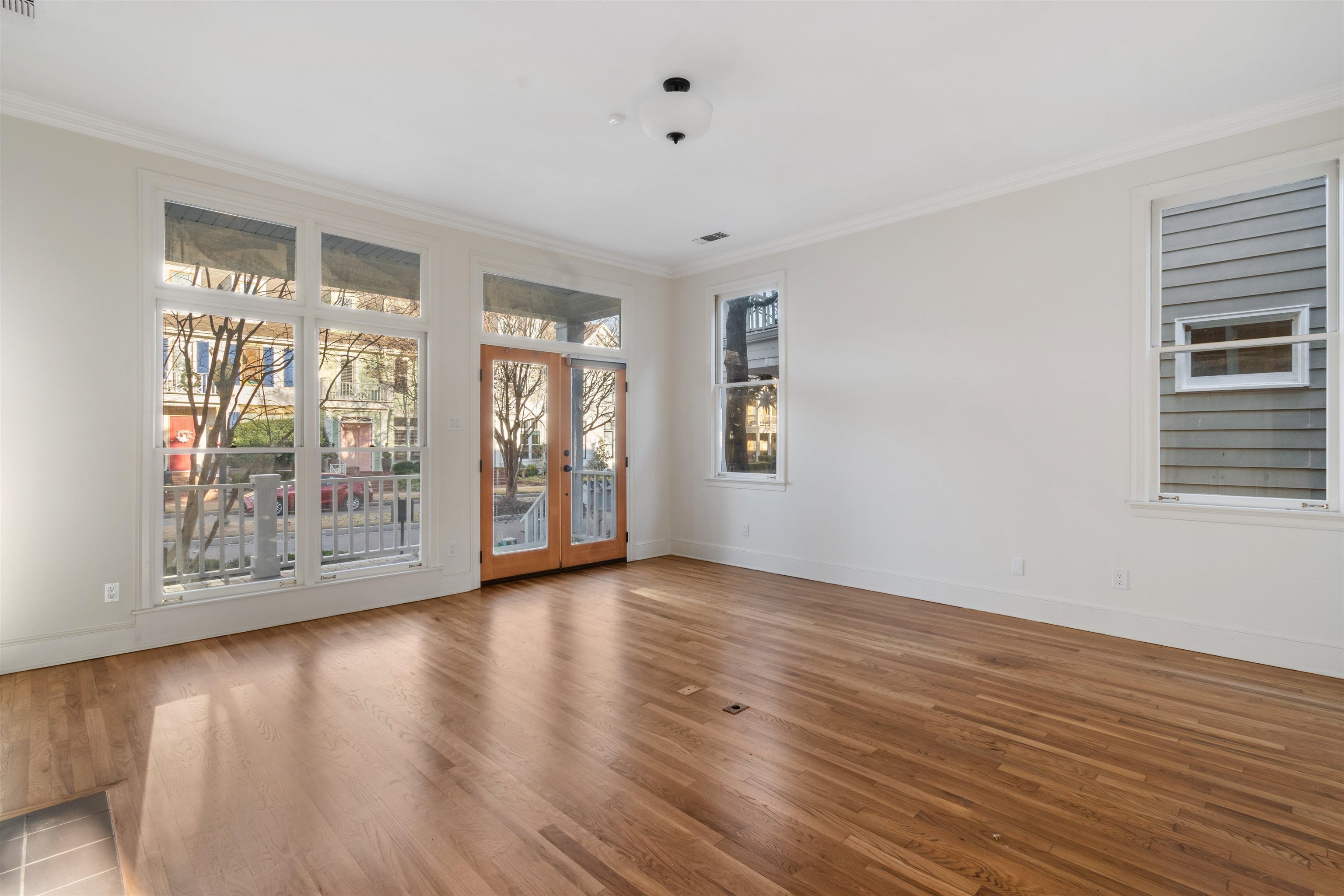 931 Harbor View Drive Memphis, TN 38103 - Photo 6 of 21 a view of an empty room with wooden floor and a window